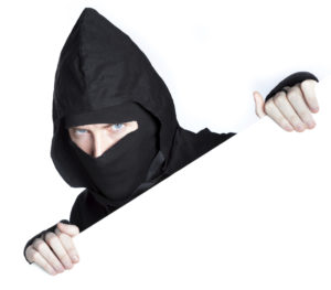 caucasian man disguised as a ninja isolated on white